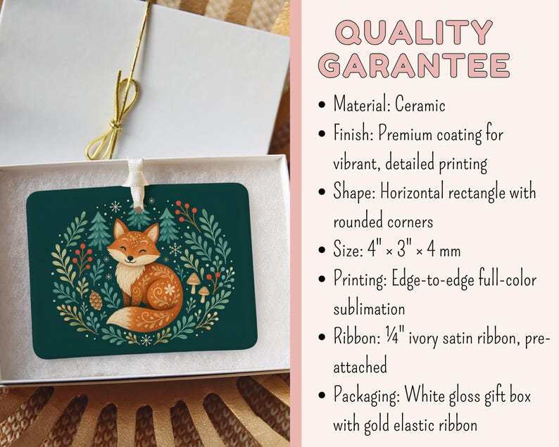 May include: A horizontal rectangular ceramic ornament with rounded corners, featuring a fox illustration surrounded by foliage on a dark green background. It includes a 0.64 cm ivory satin ribbon and comes in a white gloss gift box with a gold elastic ribbon.