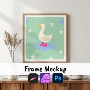 May include: A framed art print showing a cartoon duck in pink wellington boots, standing in a puddle on a light green background with white flowers. The frame is light brown. The text "Frame Mockup" is at the bottom.