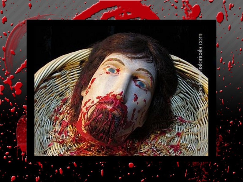 May include: A close-up of a severed head covered in blood, lying in a wicker basket. The head has a beard and is surrounded by straw. The image is from the website headleshistoricals.com.