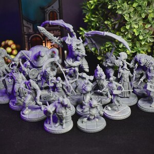 May include: A collection of gray miniature fantasy figures, including warriors, monsters, and creatures with weapons and armor. The figures are arranged on circular bases, suggesting a tabletop game or display.