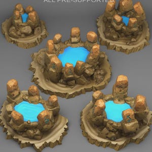May include: Five miniature fantasy terrain pieces. Each piece features a central blue pool surrounded by tan rocks and a sandy base. The rocks have a textured appearance and some have etched symbols. The overall design suggests a mystical or game-related theme.