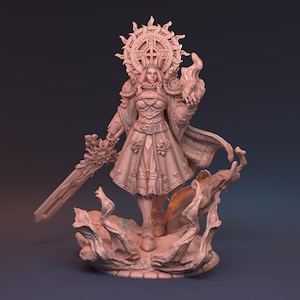 May include: A detailed, pink-toned figurine of a female warrior, adorned with a crown and a halo-like sunburst. She holds a sword and a flaming object, standing on a textured base. The figure is intricately designed, showcasing armor and a flowing gown.