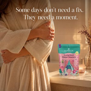 Cycle comfort self care woman in cream robe with shower steamer pouch on warm bathroom counter