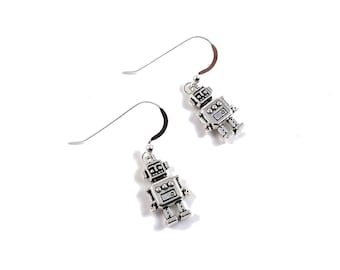 May include: A pair of silver robot earrings. Each earring features a small robot charm with a detailed design.