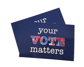 May include: Two navy blue cards with the words "your VOTE matters" in white. The word "VOTE" is in red, white, and blue. The cards are slightly overlapping, with the top card partially obscuring the text on the bottom card.
