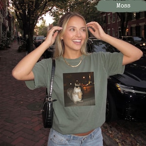 Green t-shirt with a squirrel wearing sunglasses drinking coffee graphic.