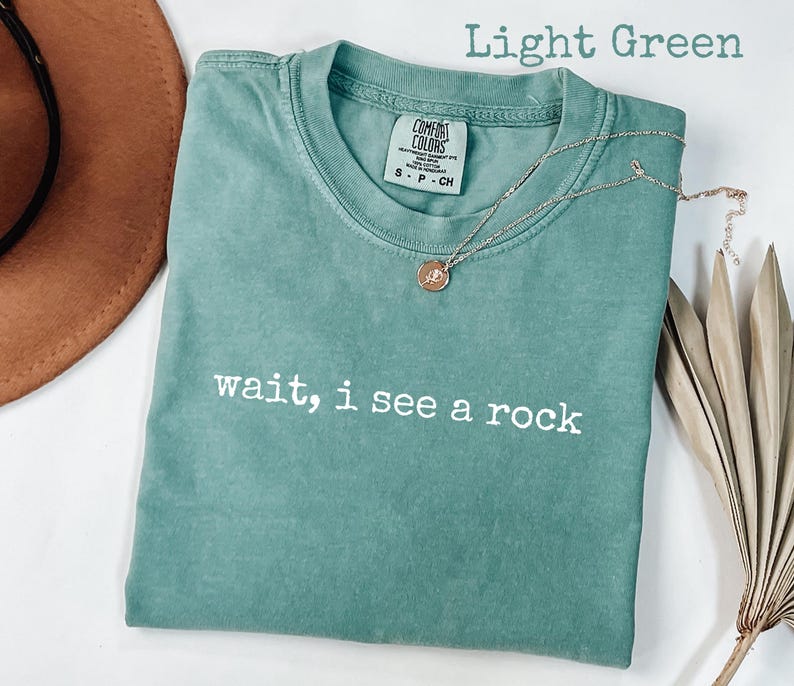 May include: A set of three ceramic mugs with a speckled, matte finish. The mugs are in shades of cream, light gray, and dark gray. Each mug has a simple, minimalist design, perfect for coffee or tea.