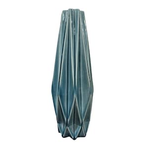 May include: A tall, teal-colored ceramic vase with a geometric, pleated design. The vase has a narrow neck and a wide, textured body. The surface has a glossy finish, reflecting light. The vase is a decorative home decor item.
