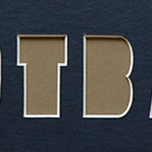 May include: The word "FOOTBALL" is cut out of a dark blue background. The letters are brown and have a white outline.