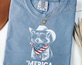 Merica Raccoon Shirt, Funny 4th of July Tee, Patriotic Animal Graphic, Comfort Colors Shirt, Gift for Her, USA Cowboy Raccoon Tee