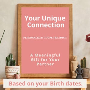 May include: A framed print with the text "Your Unique Connection" and "Personalized Couple Reading." The print is pink with white text and is on a wooden table with decorative items.