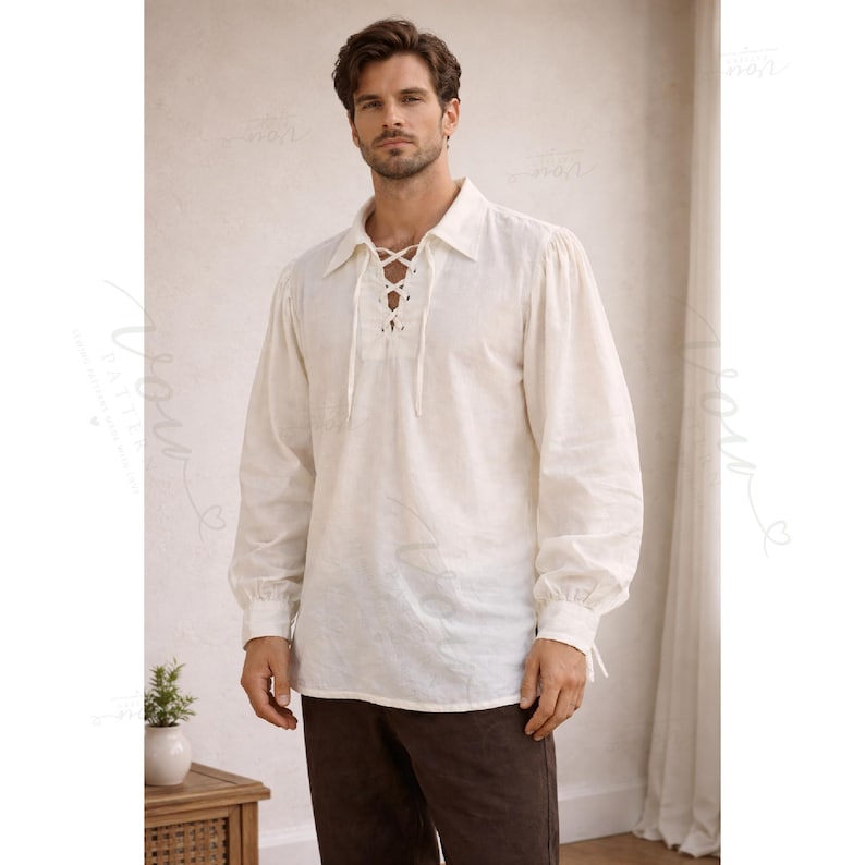 May include: An off-white long-sleeve shirt featuring a pointed collar and a front lace-up placket with matching fabric ties. The garment has full sleeves with gathered cuffs and a straight hemline, constructed from a textured, woven fabric.