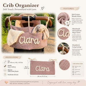 May include: A dusty rose cotton muslin crib organizer featuring the name Clara in thick white rope lettering. The rectangular organizer has two pockets, cream-colored ribbon ties, and measures 7.87 inches by 15.75 inches, weighing 0.093 pounds.