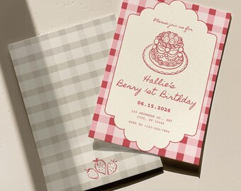 May include: A pink and white gingham birthday invitation with a strawberry cake illustration. The invitation reads "Hallie's Berry 1st Birthday" with the date and RSVP information. The envelope has a gray and white plaid pattern.