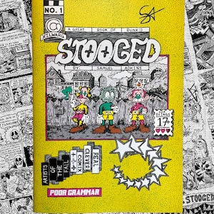 May include: A yellow comic book titled "STOOGED" with the text "No. 1" and "Xilwarg." The cover features cartoon characters and the text "A Great Book of Bunk:)" and "By: Samuel Adkins." The comic is rated 17+ and has a "Poor Grammar" label.