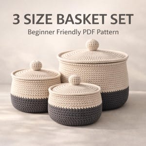 May include: A set of three crochet baskets with lids, in varying sizes. The baskets are two-toned, with a cream-colored top and a dark gray base. The image includes the text "3 SIZE BASKET SET" and "Beginner Friendly PDF Pattern".