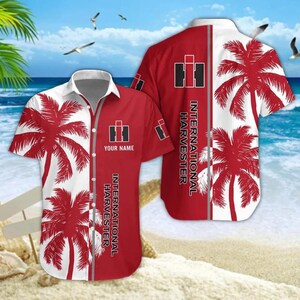 May include: Red and white short-sleeve button-down shirt with a palm tree design. The shirt features the "International Harvester" logo and text. The shirt has a white collar and a split design with red and white panels.