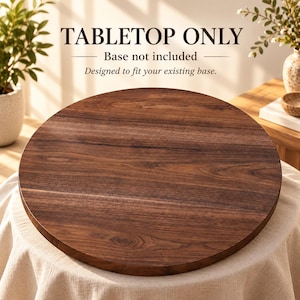 May include: A round, dark brown wooden tabletop with a visible wood grain pattern. The text on the image reads: TABLETOP ONLY, Base not included, Designed to fit your existing base. This is a flat, circular wooden surface for furniture.