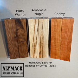 May include: A set of three ceramic mugs with a speckled, matte finish. The mugs are in shades of cream, light gray, and dark gray. Each mug has a simple, minimalist design and a rounded handle.