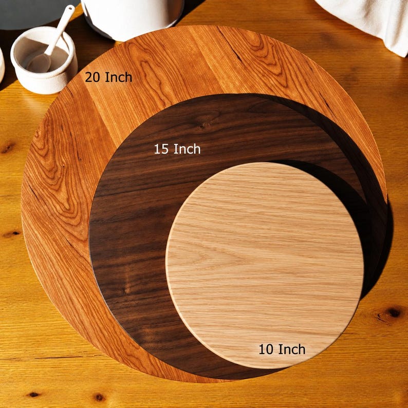 May include: Three circular wooden boards stacked on top of each other. The largest board is light brown with a visible grain, labeled 20 Inch. The middle board is dark brown, labeled 15 Inch. The smallest board is light tan, labeled 10 Inch.