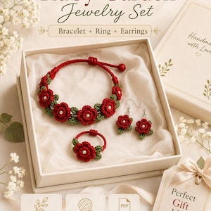 May include: A jewelry set in a box featuring a crocheted bracelet, ring, and earrings with red flowers, green leaves, and white centers. Text includes Ruby Garden Jewelry Set, Bracelet + Ring + Earrings, Handmade with Love, Beginner-Friendly, US Terms, Printable PDF, and Perfect Gift Idea.