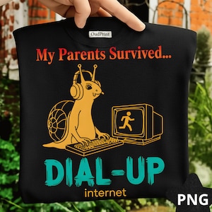 May include: Black sweatshirt featuring a cartoon snail with headphones, using a computer. The text says "My Parents Survived... DIAL-UP internet". The snail is yellow, and the text is in red and teal.