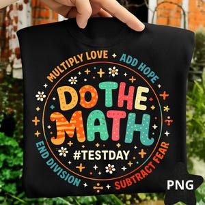 May include: Black sweatshirt with a colorful graphic that says "DO THE MATH" in large letters. The design includes the phrases "MULTIPLY LOVE + ADD HOPE", "END DIVISION", and "SUBTRACT FEAR". The hashtag "#TESTDAY" is also included.