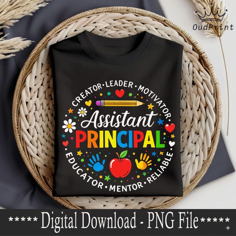 May include: Black t-shirt featuring a design for an Assistant Principal. The design includes the words "Assistant Principal" in bright colours, surrounded by words like "Creator," "Leader," and "Educator," along with a pencil, apple, and handprints.