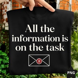 May include: Black sweatshirt with the text "All the information is on the task" in white. Below the text is a white envelope graphic with a red and white emblem. The sweatshirt is held up by a hand.