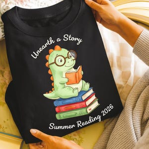 May include: A white ceramic mug with a black handle and the text "But First, Coffee" in a handwritten style. The mug is on a white surface. The mug is 4 inches tall.