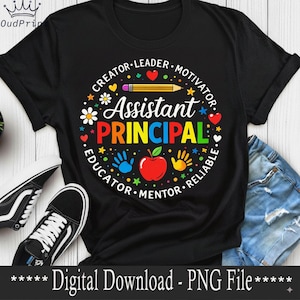 May include: Black t-shirt featuring a colourful graphic for an Assistant Principal. The design includes the words "Assistant Principal" in rainbow colours, surrounded by words like "Creator" and "Educator", and images of an apple, hands, and a pencil.