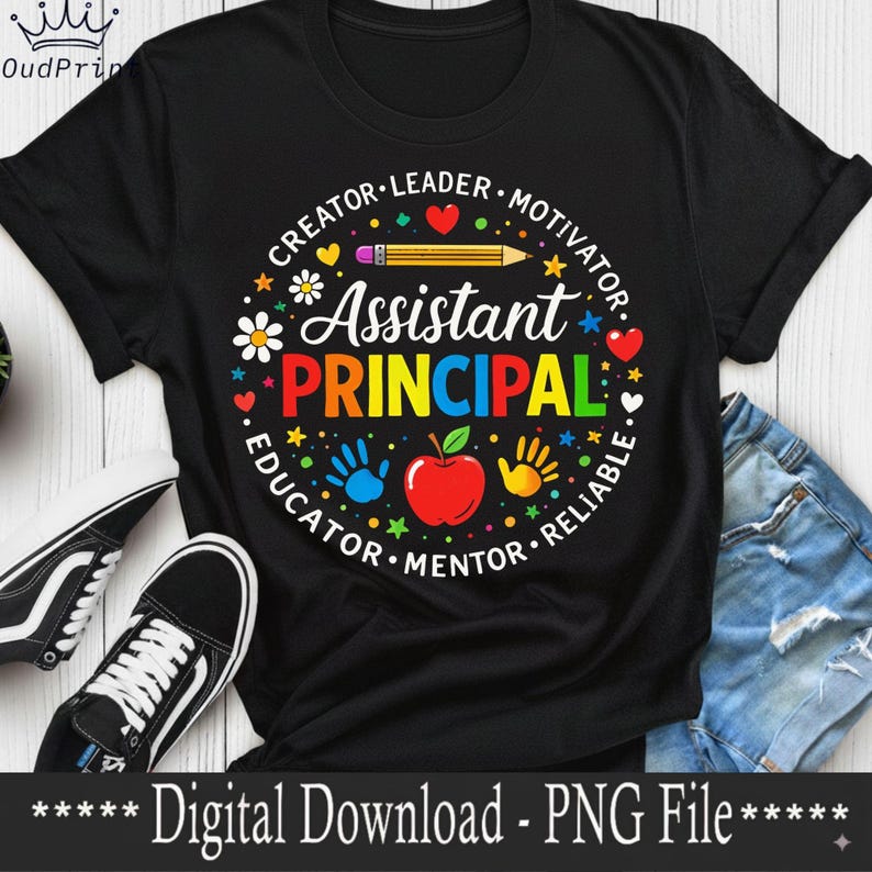 May include: Black t-shirt featuring a colourful graphic for an Assistant Principal. The design includes the words "Assistant Principal" in rainbow colours, surrounded by words like "Creator" and "Educator", and images of an apple, hands, and a pencil.