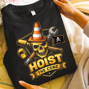 May include: Black sweatshirt with a graphic featuring a skull wearing a traffic cone, crossed tools, and a pirate flag. The text "HOIST THE CONE" is displayed in gold lettering on a banner.