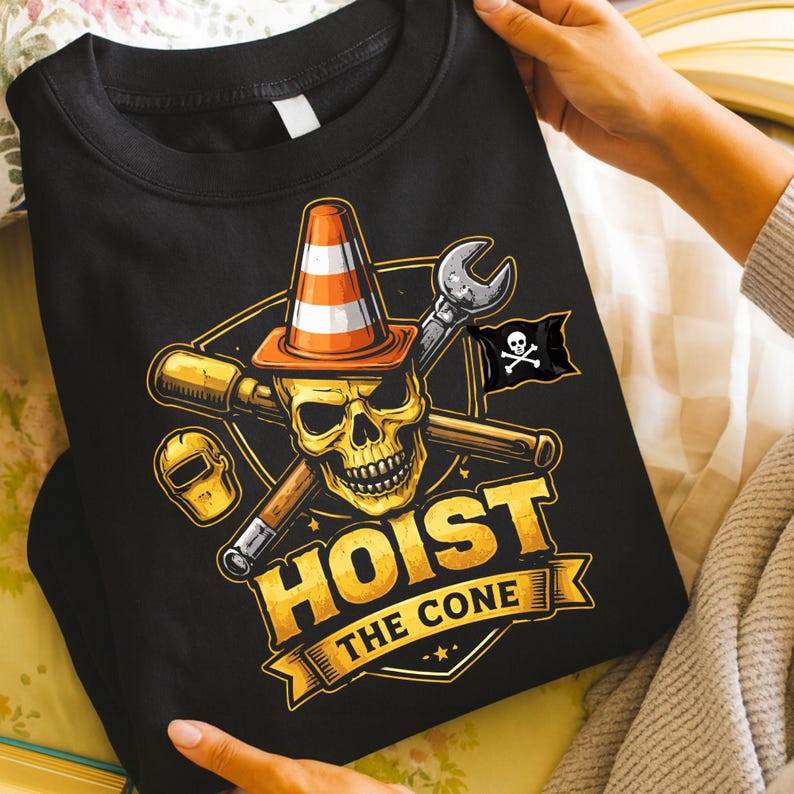 May include: Black sweatshirt with a graphic featuring a skull wearing a traffic cone, crossed tools, and a pirate flag. The text "HOIST THE CONE" is displayed in gold lettering on a banner.
