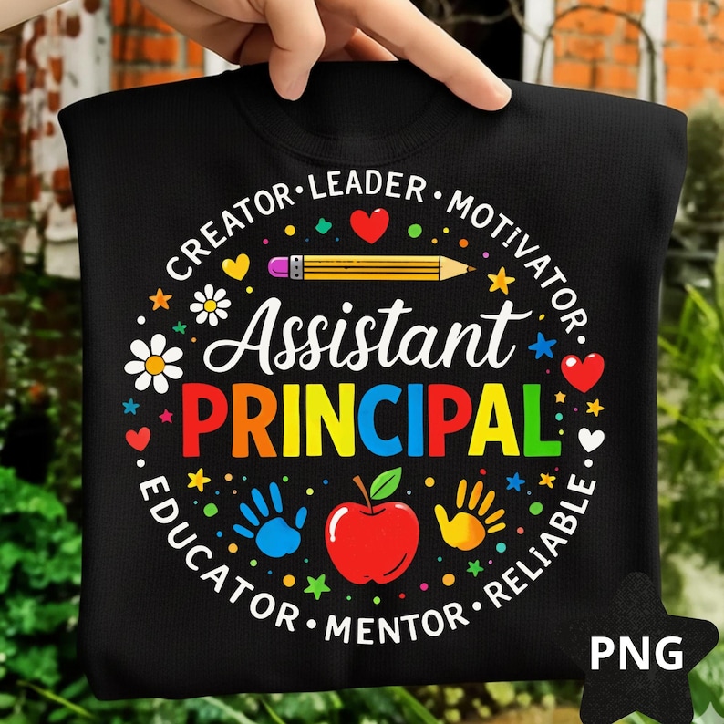 May include: Black sweatshirt featuring the words "Assistant Principal" in vibrant colours. The design includes a pencil, apple, handprints, hearts, and stars, with the words "Creator, Leader, Motivator, Educator, Mentor, Reliable" around the design.