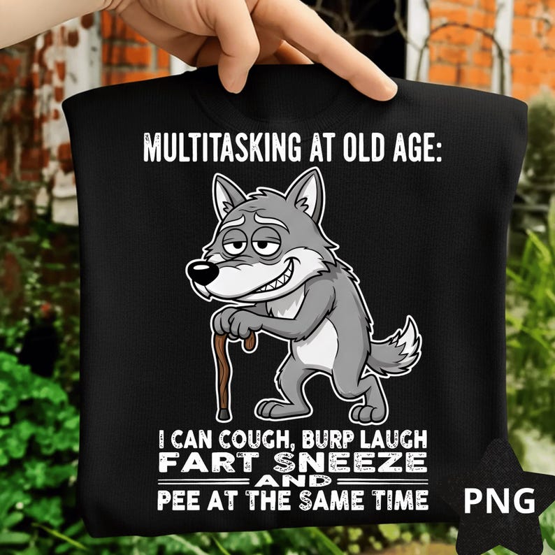 Pu&ograve; includere: T-shirt nera con la scritta "MULTITASKING AT OLD AGE: I CAN COUGH, BURP LAUGH FART SNEEZE AND PEE AT THE SAME TIME" e un lupo dei cartoni animati con un bastone. Il lupo &egrave; grigio e bianco.