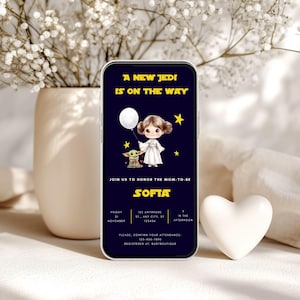 Star Wars baby shower invitation flat lay on a light surface with stationery props, featuring chibi Princess Leia holding a balloon and Baby Yoda, galaxy background, editable Canva template.