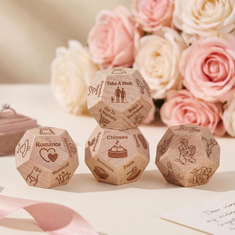 May include: A set of wooden activity dice with engraved icons and text, such as "Romance," "Take a Walk," and "Chinses." The dice are light brown and feature various activity suggestions. A bouquet of pink roses is in the background.