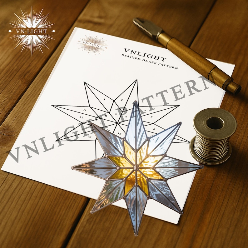 May include: A stained glass star with gold and clear glass panels, next to a pattern sheet and tools. The pattern sheet has the text "VN-LIGHT STAINED GLASS PATTERN". A spool of wire and a brass tool are also visible.