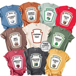 May include: A collection of nine short-sleeved t-shirts in various colors, each featuring a graphic design shaped like a condiment bottle label. The labels display text such as Real Mayonnaise, Cool Ranch Dressing, Green Chili Sauce, Spicy Salsa, Original BBQ Sauce, Custom Text, Spicy Wasabi Sauce, Hot Sriracha Sauce, Gourmet Balsamic Vinegar, and Cheesy Queso Dip.