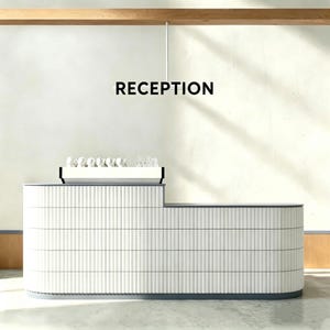 May include: A modern white reception desk with a textured, vertical-line design. The desk has a curved shape and a dark gray trim. The word "RECEPTION" is displayed in black above the desk. Several white cups and glasses are on the desk.