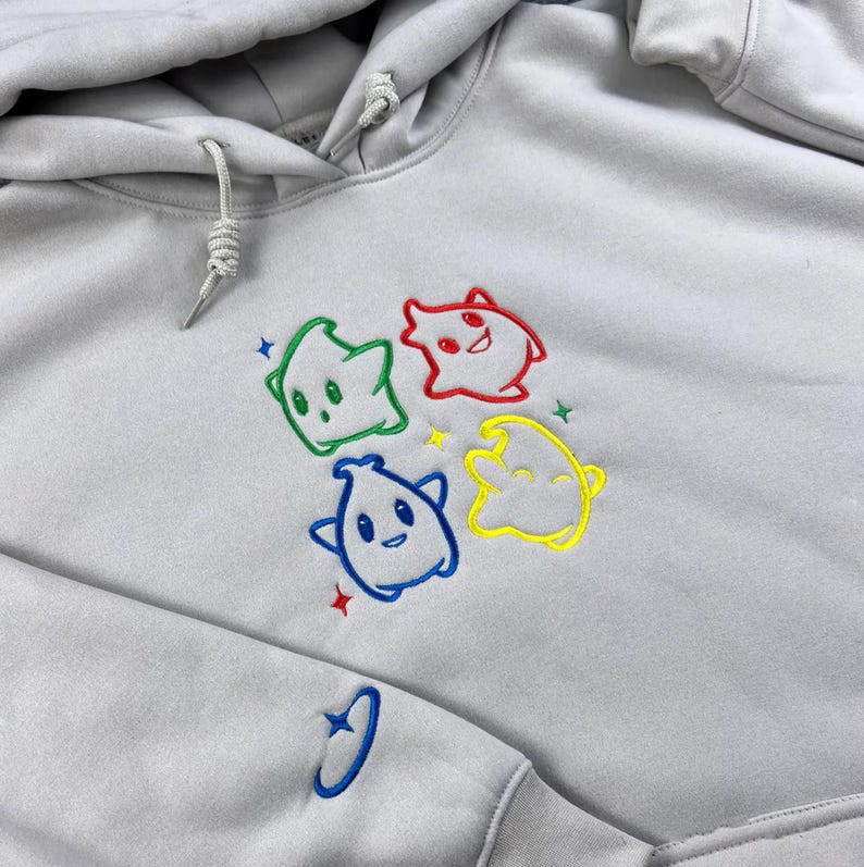 May include: A white ceramic mug with a black handle and the text "But First, Coffee" in a black, handwritten-style font. The mug is on a white surface.