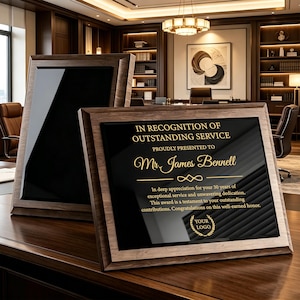 May include: Two rectangular wooden plaques with dark brown frames and black centers. The front plaque features gold text reading: IN RECOGNITION OF OUTSTANDING SERVICE, PROUDLY PRESENTED TO Mr. James Bennell, and a laurel wreath logo with YOUR LOGO.