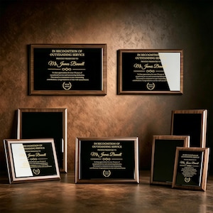 May include: A collection of rectangular wooden plaques with black glass centers. Each plaque features gold text reading IN RECOGNITION OF OUTSTANDING SERVICE, PROUDLY PRESENTED TO Mr. James Bennett, and includes a laurel wreath logo at the bottom.