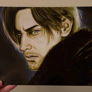 May include: A portrait print featuring a man with light blue eyes and short, light brown hair. He is wearing a black coat with a fur collar. The artwork has a detailed, realistic style with a focus on the subject's face.
