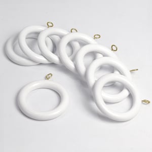 May include: A collection of white curtain rings with brass-colored eyelets. The rings are made of a smooth, glossy material and are arranged in a slightly overlapping pattern. The rings are designed for hanging curtains.