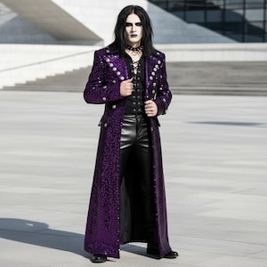 May include: A long, purple sequined coat with silver buttons. The coat is worn over a black top and black leather pants. The coat has a classic, tailored design, and the overall look is gothic-inspired.