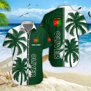 May include: A short-sleeved button-down shirt with a tropical design. The shirt features a split design with a white and green color scheme, palm tree silhouettes, and the name "OLIVER" vertically printed. The shirt also has a crest with the text "OLIVER" and "FINEST IN FARM MACHINERY".