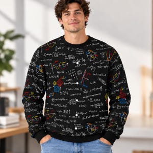 May include: A black crewneck sweatshirt featuring an all-over print of white mathematical equations, geometric diagrams, and colorful wave graphs. The design includes various calculus and trigonometry formulas printed across the fabric.