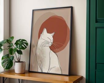 May include: A framed art print featuring a minimalist line drawing of a cat. The cat is white with black outlines, set against a backdrop of tan and rust-colored circles. The artwork is displayed on a wooden surface.